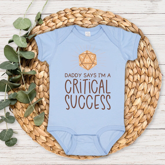 Daddy Says I'm A Critical Success Baby Bodysuit